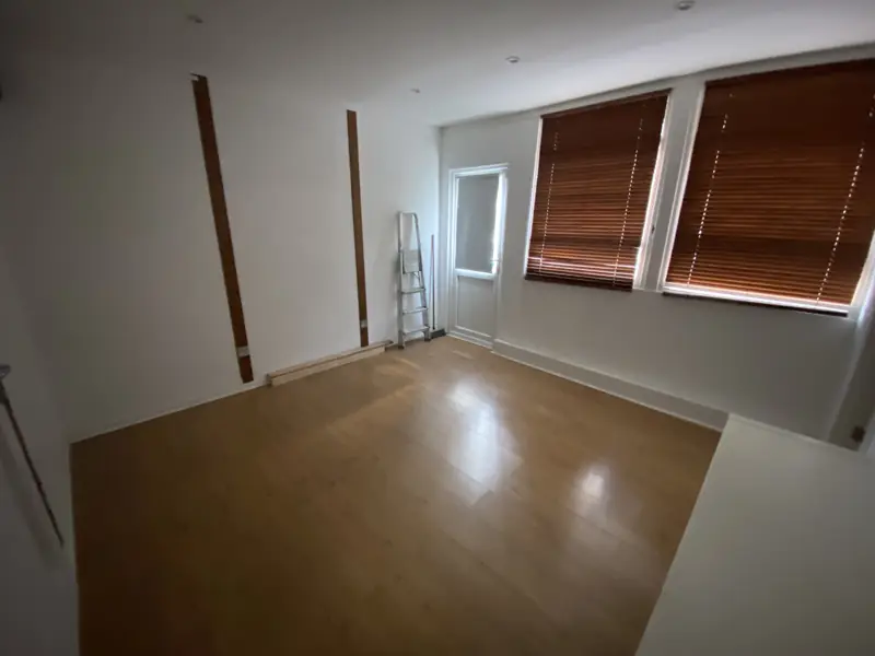 Room with blinds and wood floor